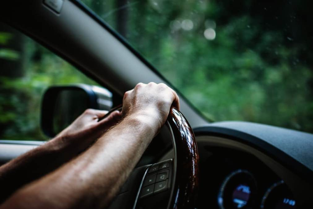 hand-on-wheel-of-car-driving